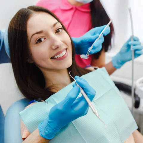 A smiling patient in the dental chair during an exam